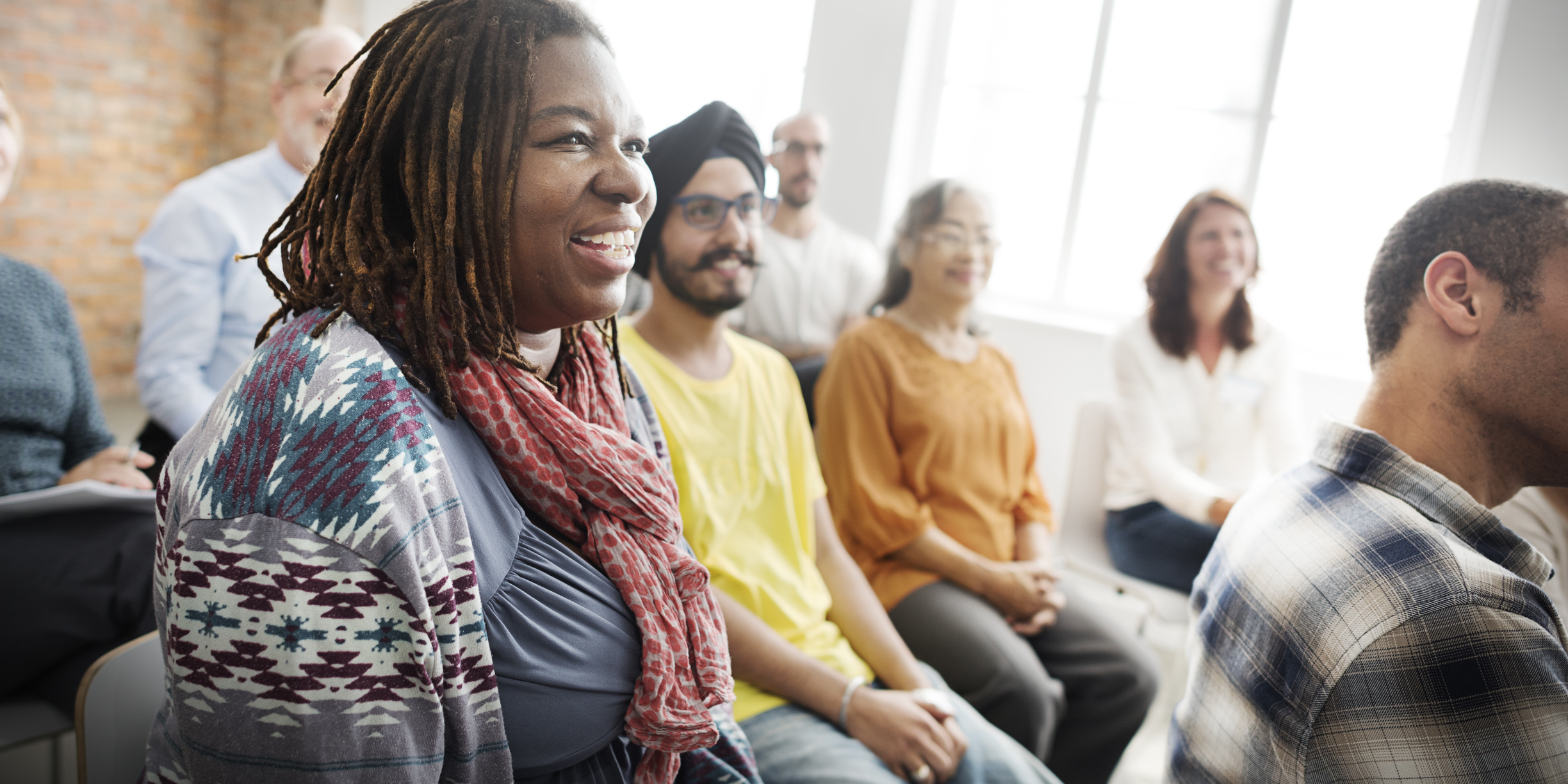 Small group of event attendees listening to an instructor Small group of event attendees listening to an instructor